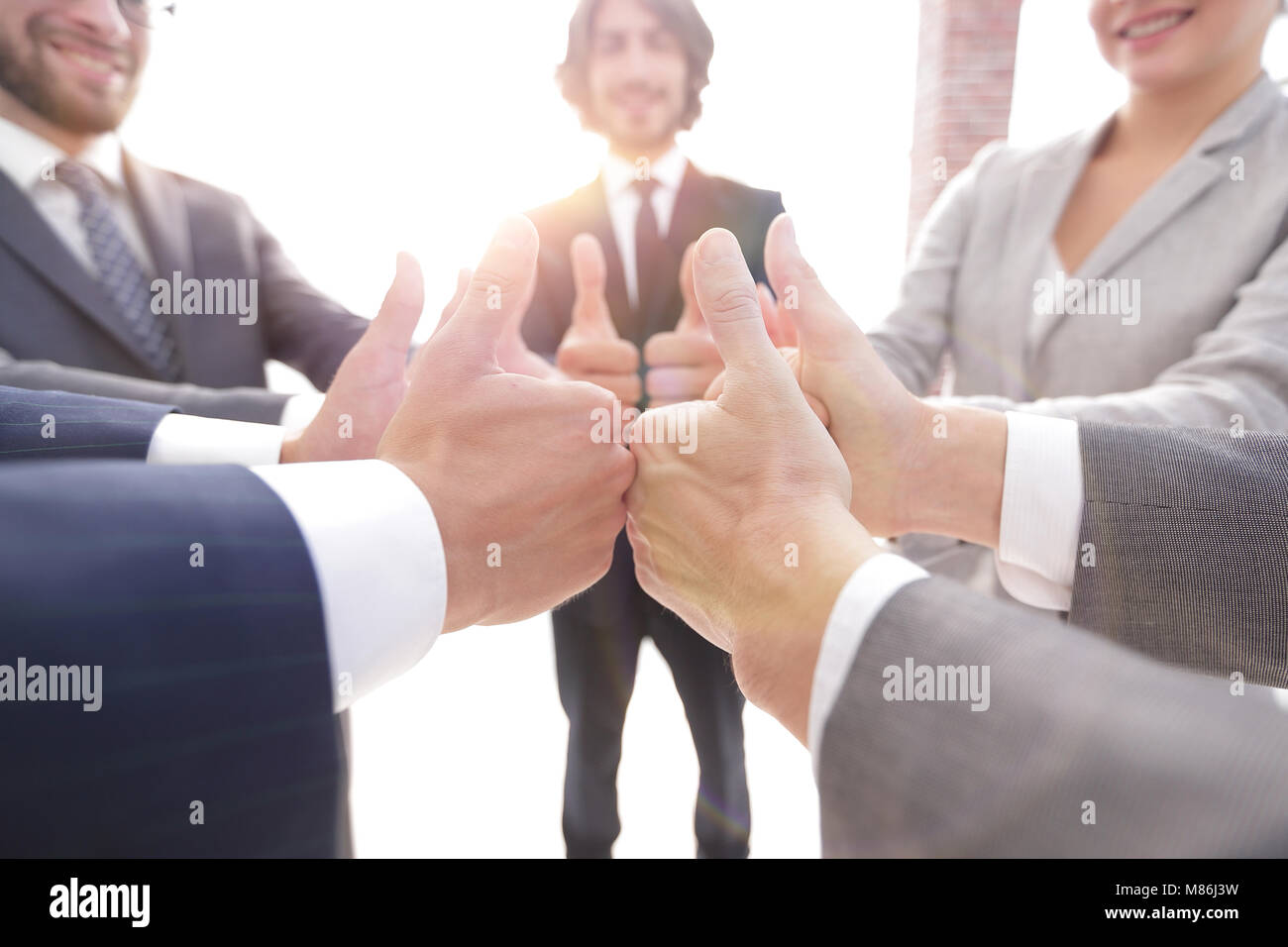 business team showing thumbs up Stock Photo - Alamy