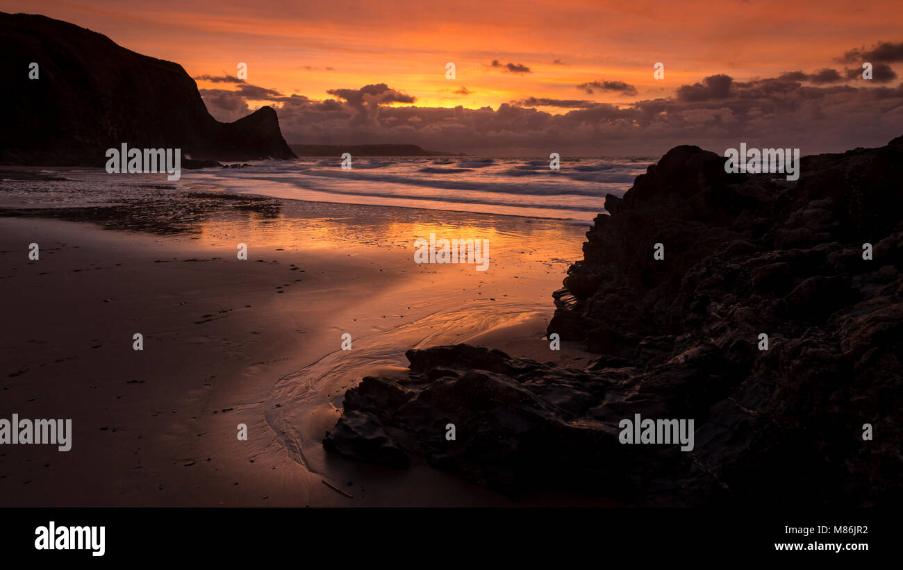Llangrannog beach at sunset at low tide, Wales coast Stock Photo