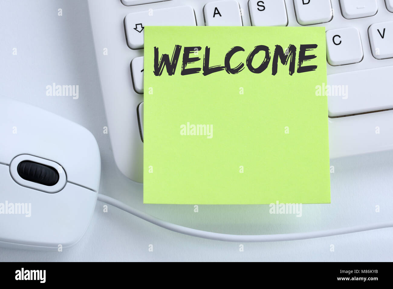 Welcome new employee colleague refugees refugee immigrants computer business concept mouse desk keyboard Stock Photo