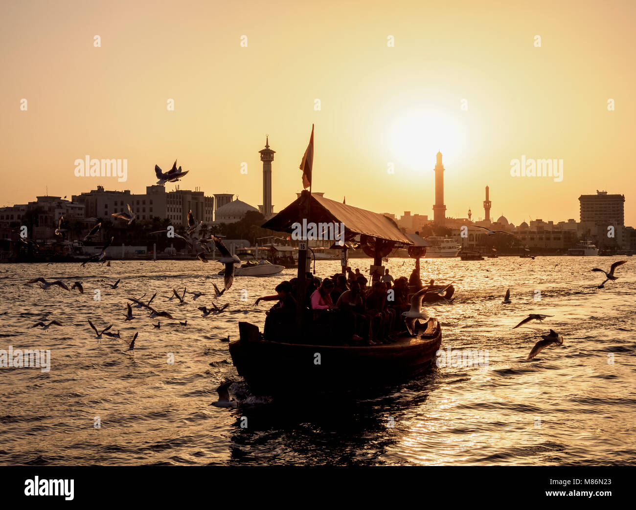 Abra Boat on Dubai Creek at sunset, Dubai, United Arab Emirates Stock Photo