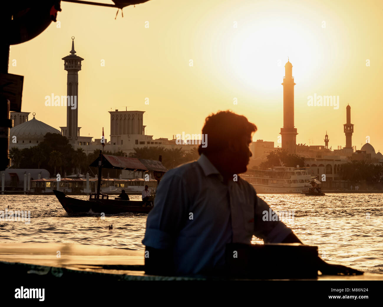 Abra Boats on Dubai Creek at sunset, Dubai, United Arab Emirates Stock Photo