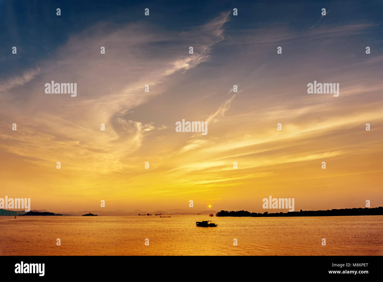 Silhouette of fishing boat at sea during sunset Stock Photo - Alamy