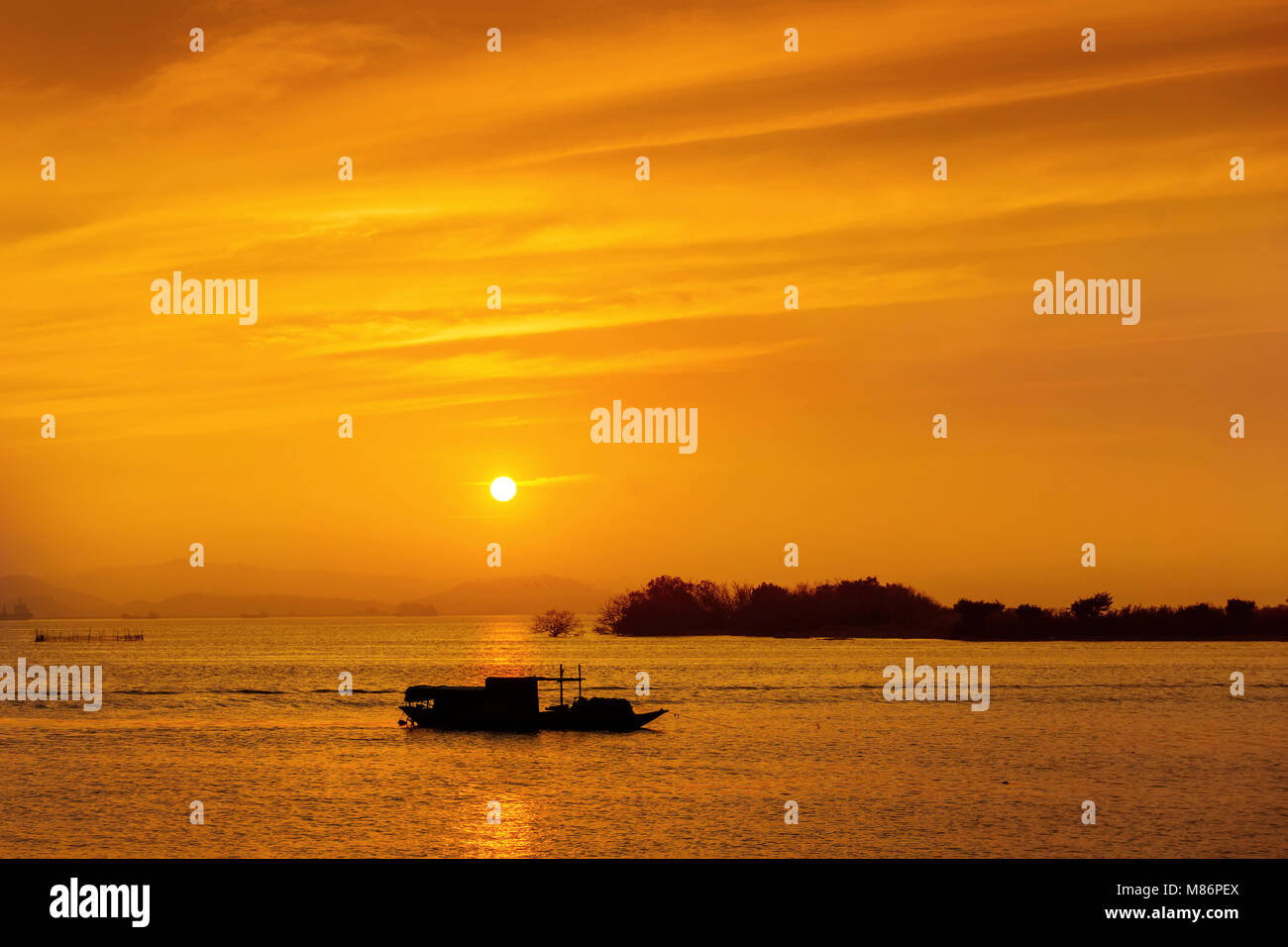 Silhouette of fishing boat at sea during sunset Stock Photo - Alamy