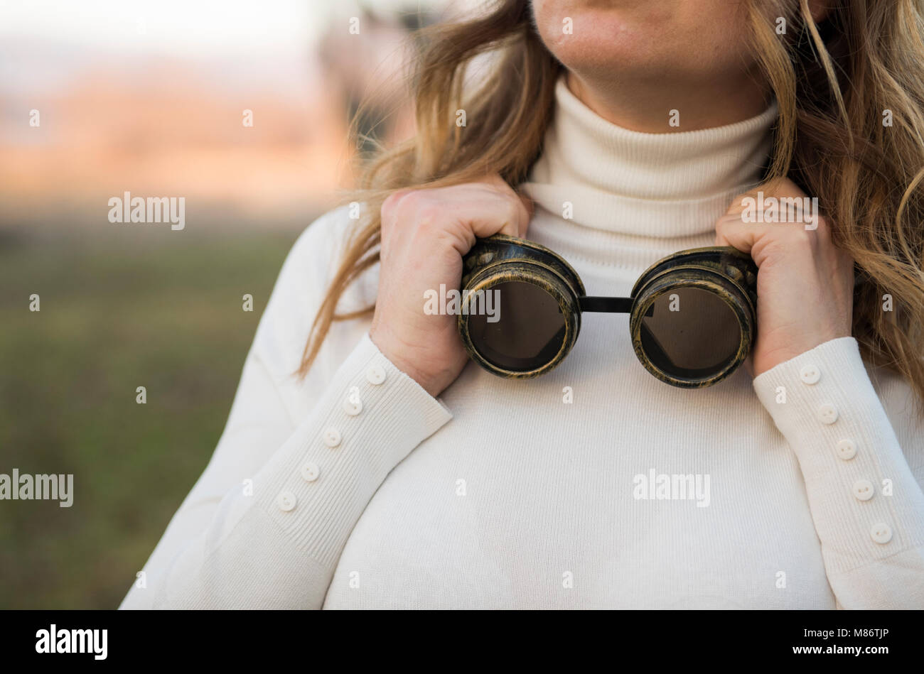 Portrait of a woman with goggles around her neck Stock Photo - Alamy