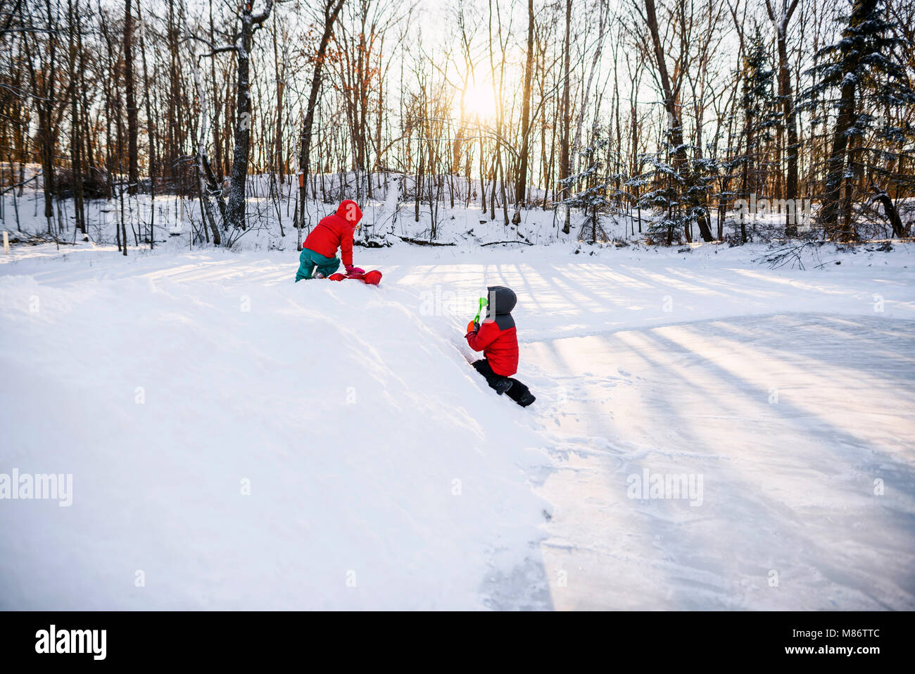 Two boys ice fishing on a frozen lake. Stock Illustration by ©AlexBannykh  #31115139