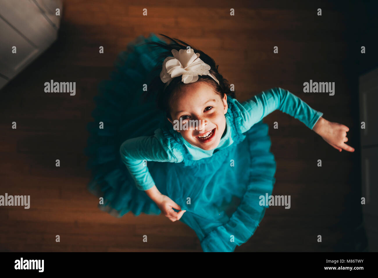 Overhead view of a happy girl spinning around Stock Photo