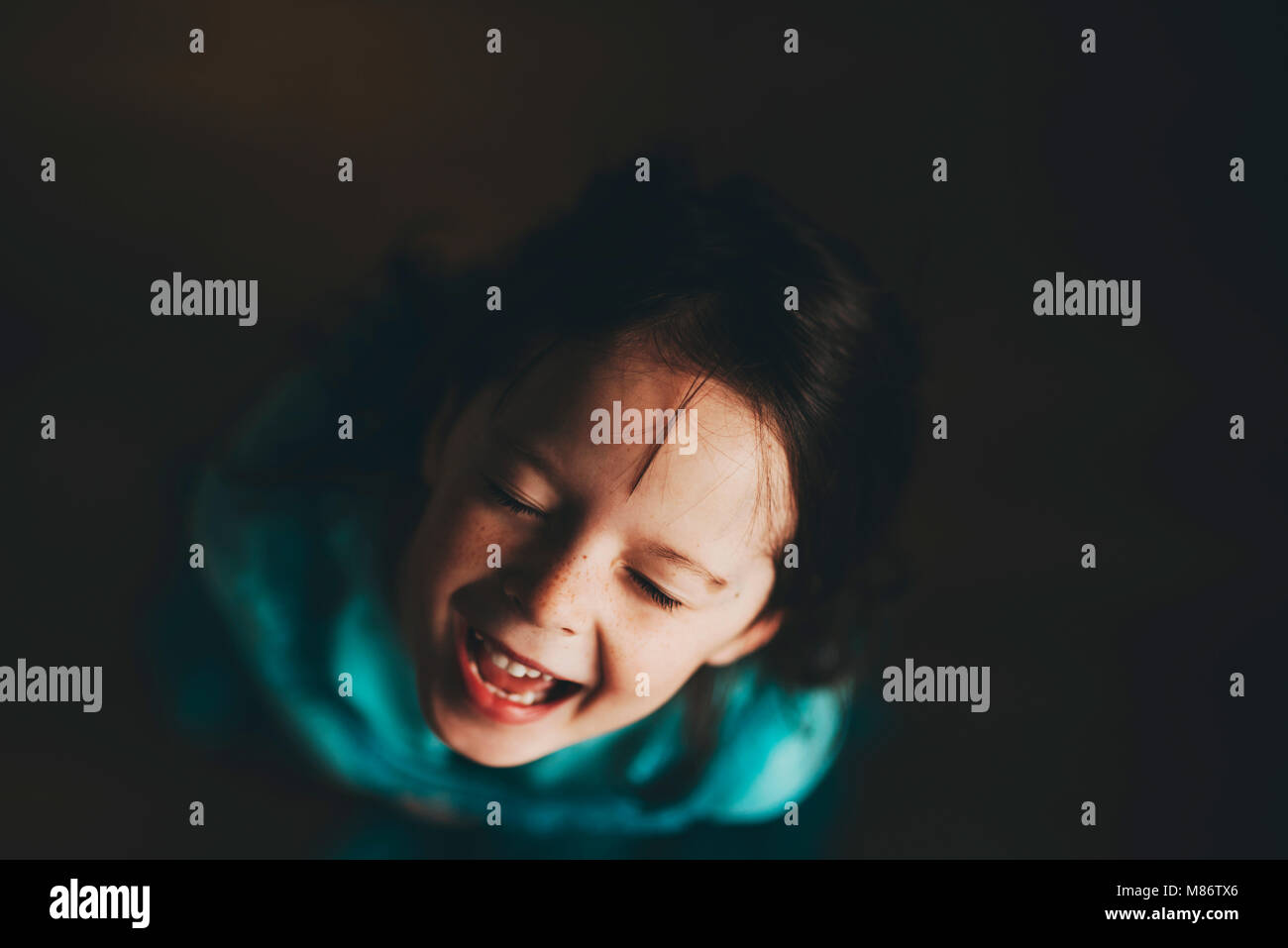 Overhead of young girl laughing Stock Photo
