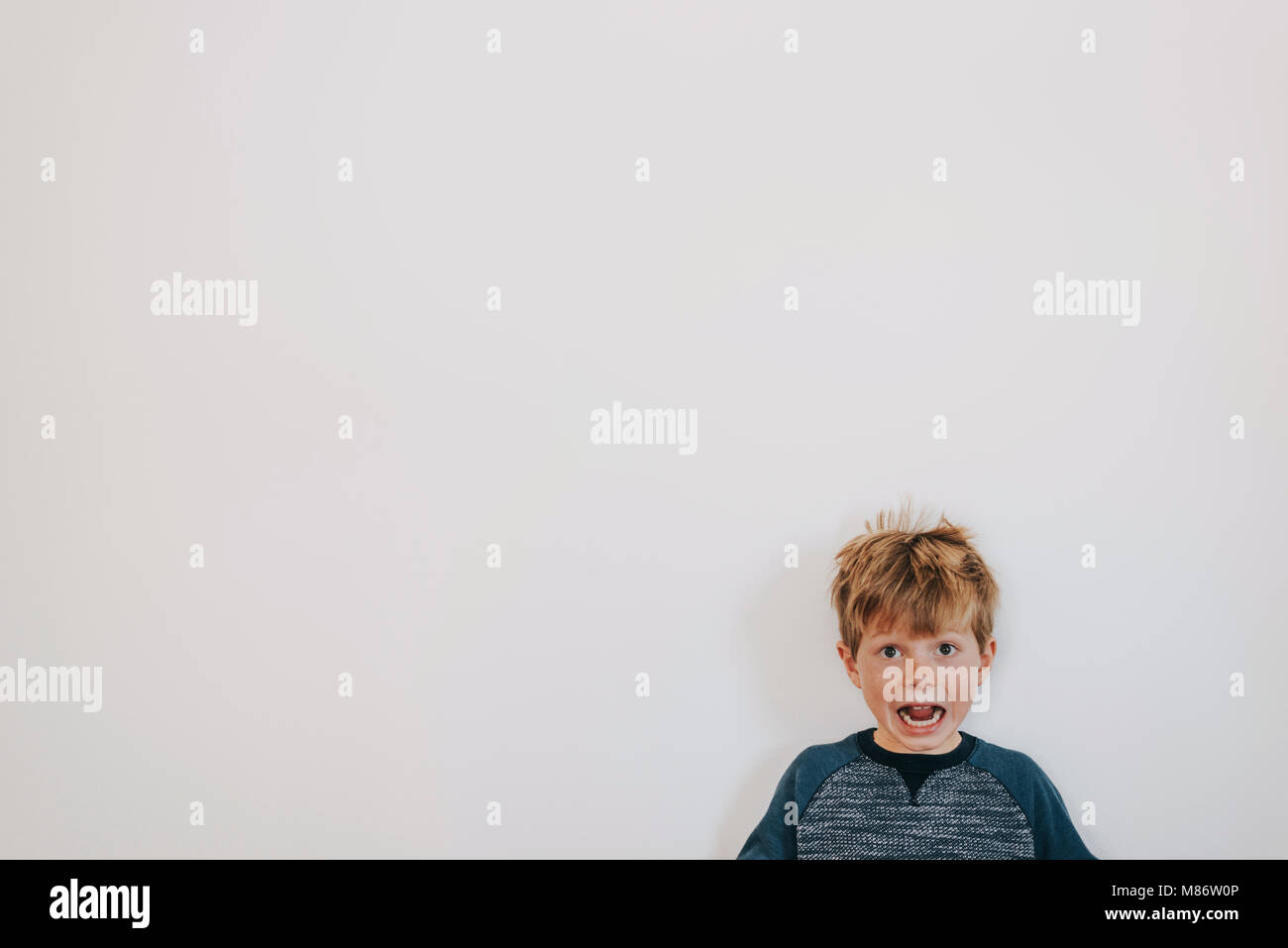 Portrait of a boy with freckles shouting Stock Photo
