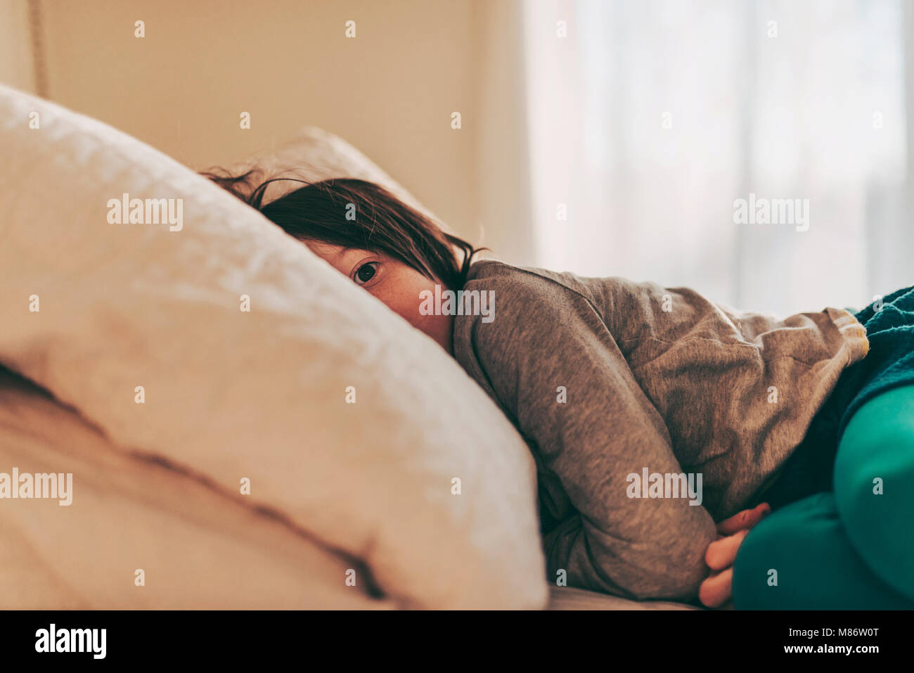 Girl lying on her bed having a nap Stock Photo