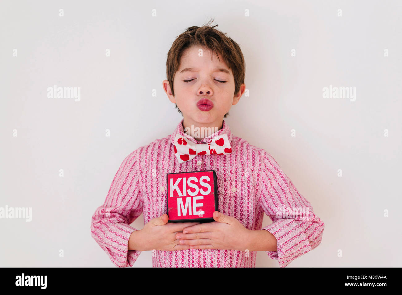 Smiling boy holding a Kiss me box Stock Photo