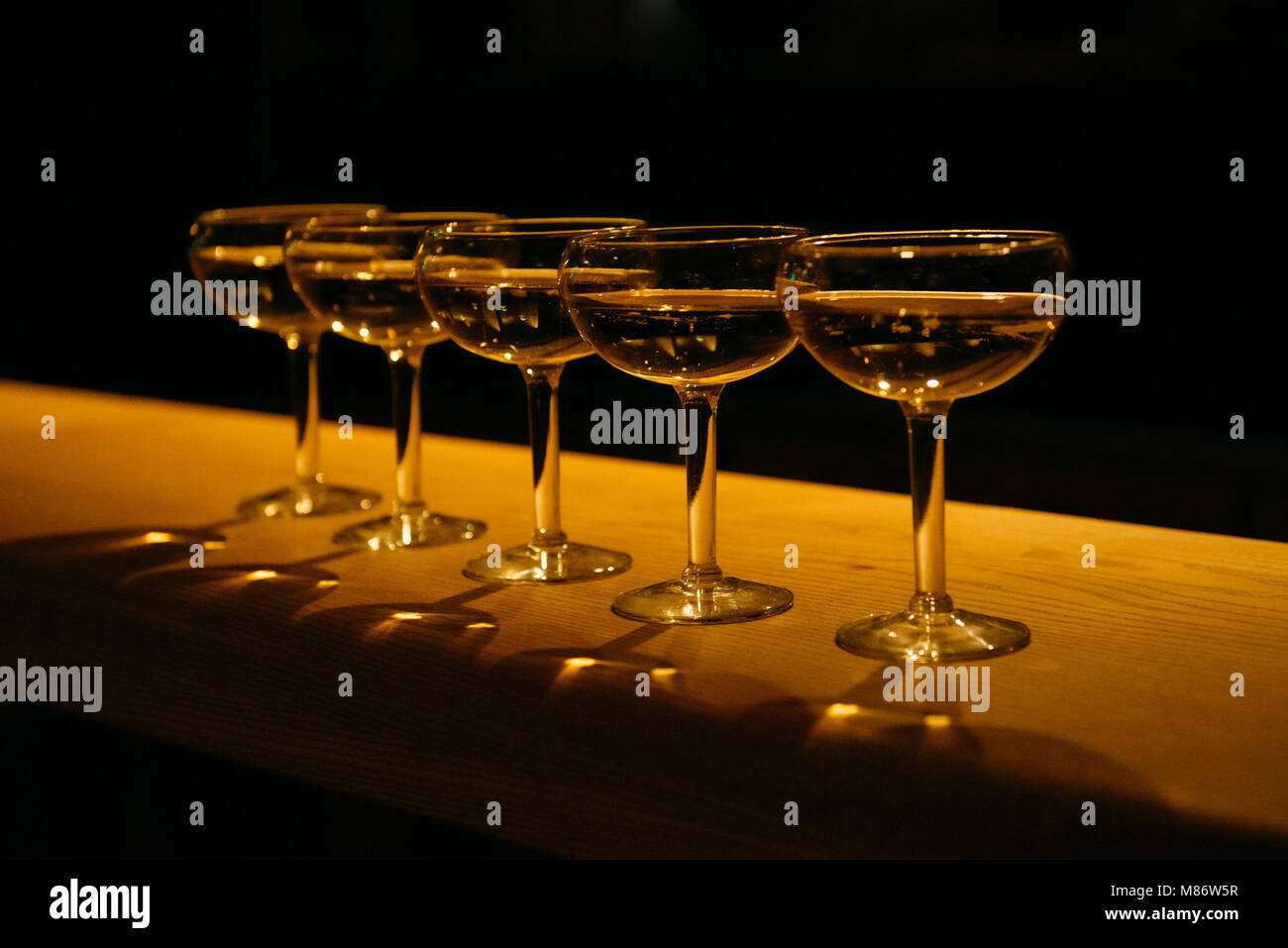 Row of champagne coupe glasses Stock Photo Alamy