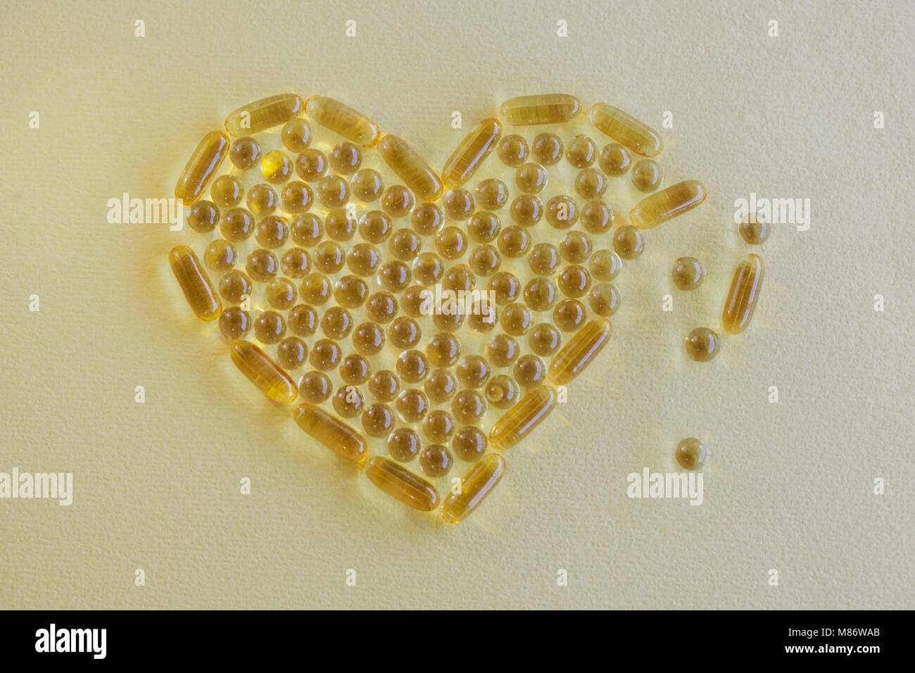 Capsules in a broken heart shape Stock Photo
