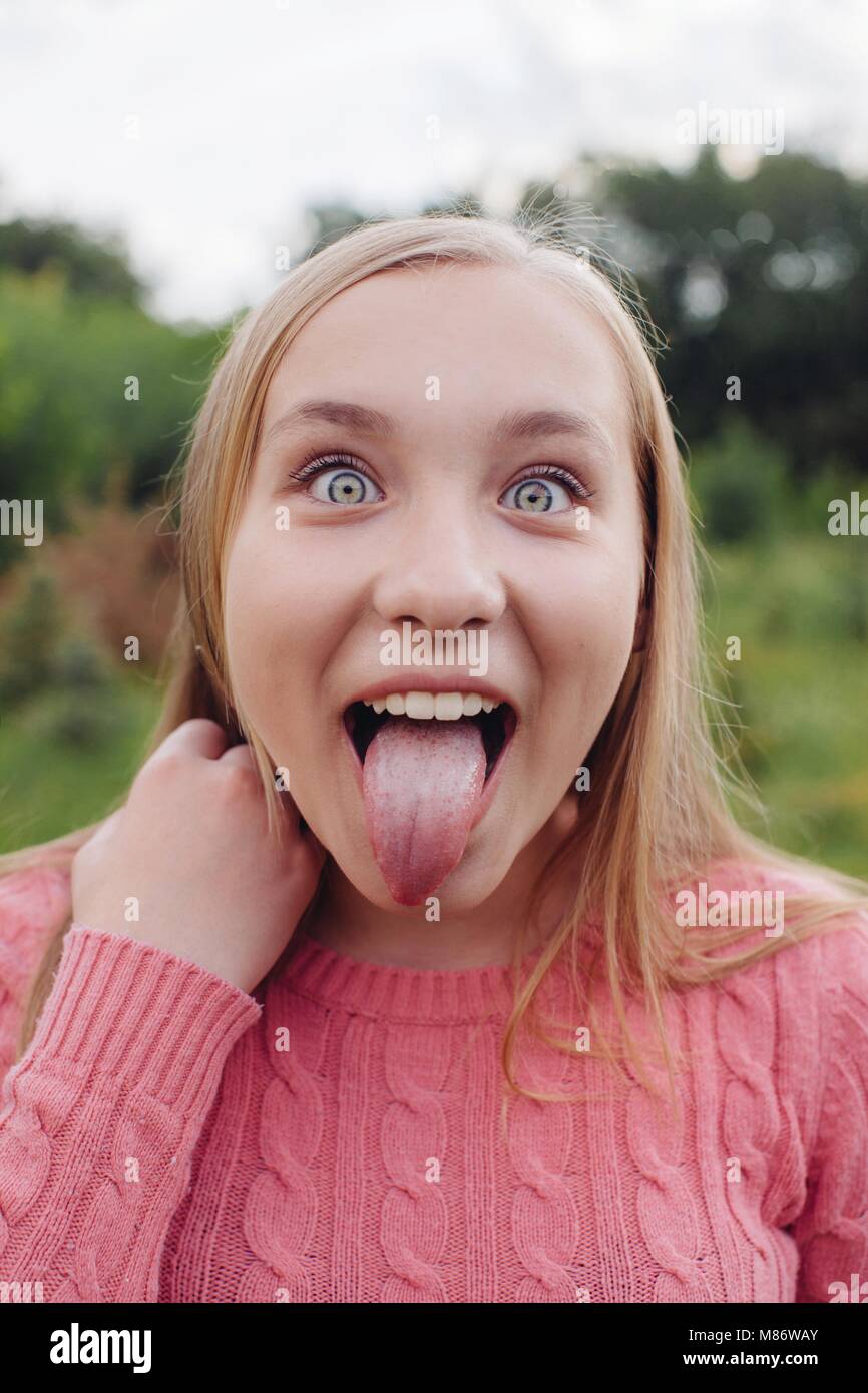 Portrait of a girl sticking out her tongue Stock Photo