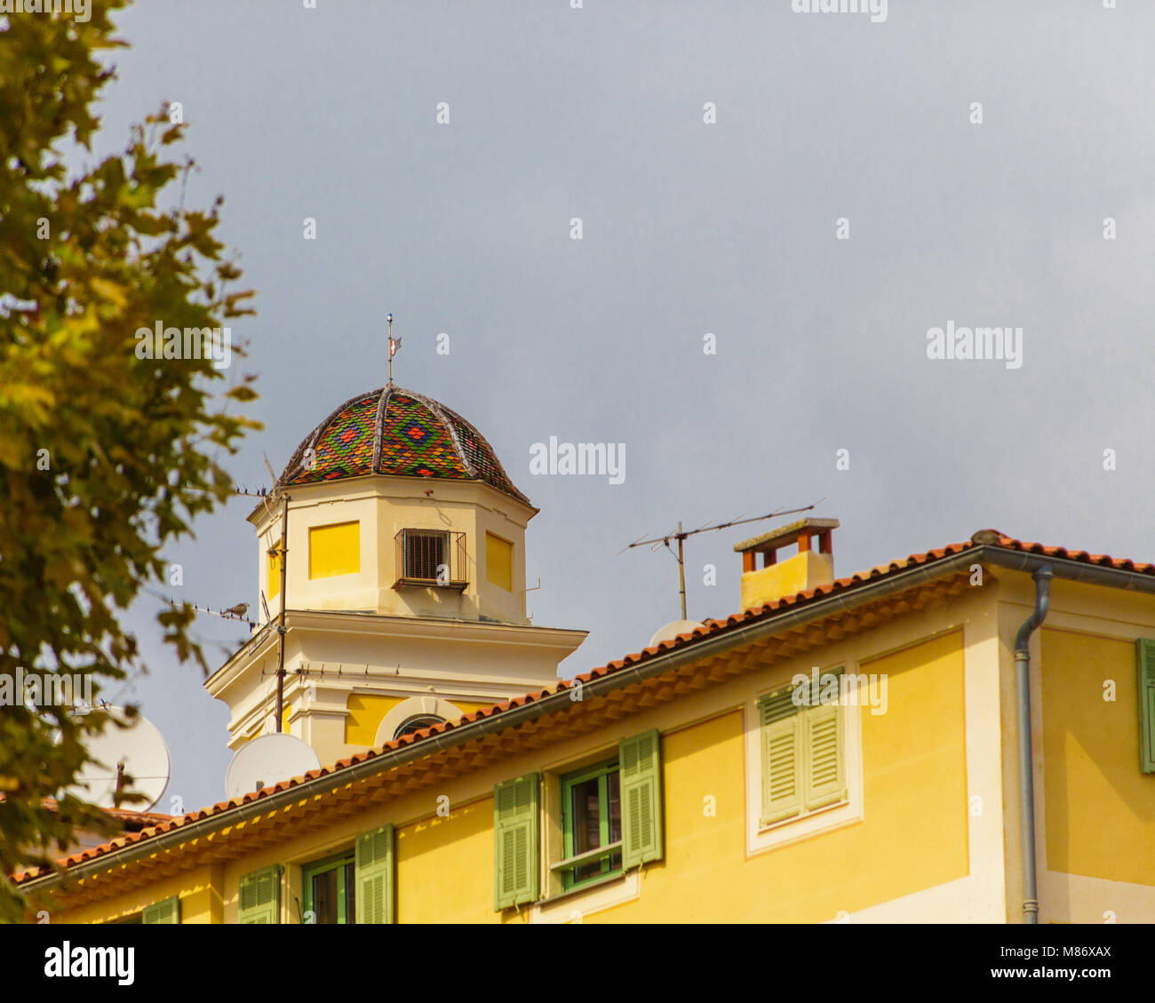Design of Colorful Rooftiles on Cupola on Yellow Building Stock Photo