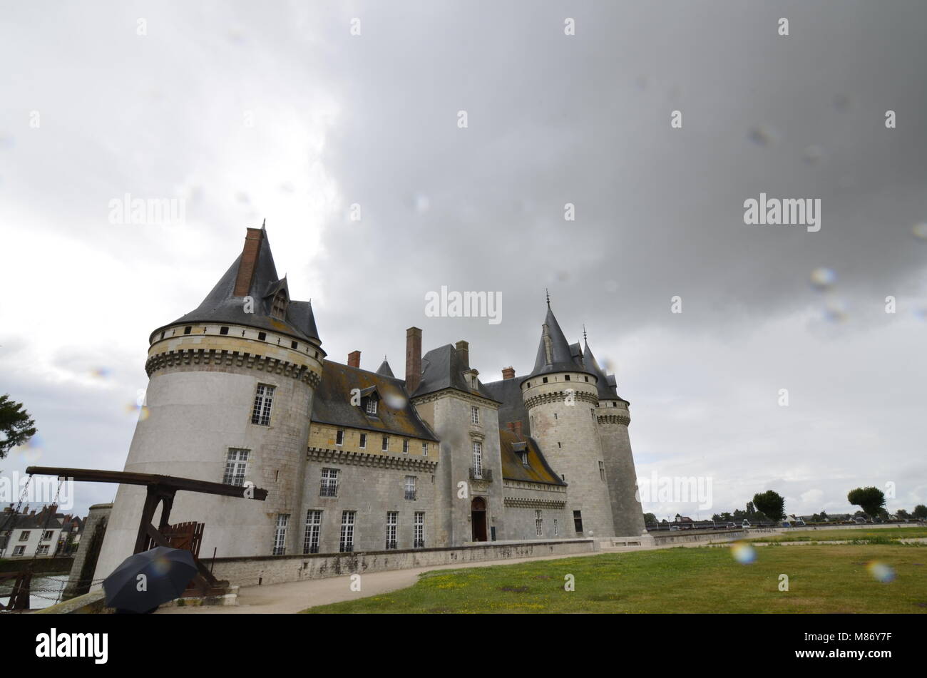 Castle of Sully-sur-Loire, Loire region, France. Snap of 30 June 2017 17:38. Shooting from the park towards the castle entrance. The façade is mirrore Stock Photo