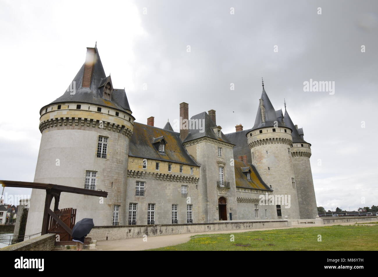Castle of Sully-sur-Loire, Loire region, France. Snap of 30 June 2017 17:38. Shooting from the park towards the castle entrance. The façade is mirrore Stock Photo