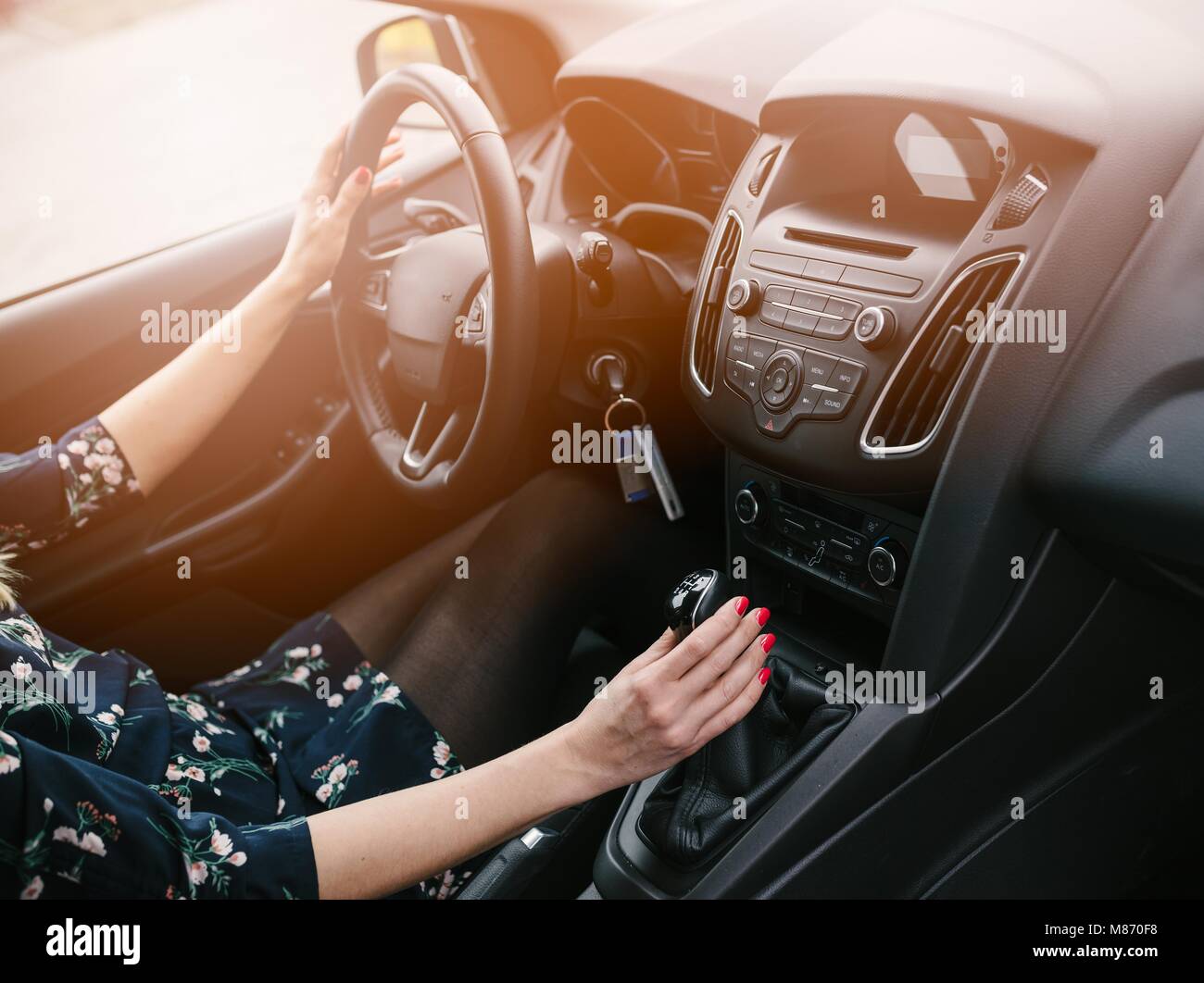 Young woman changing gears in car. Driving a car. Manual transmission