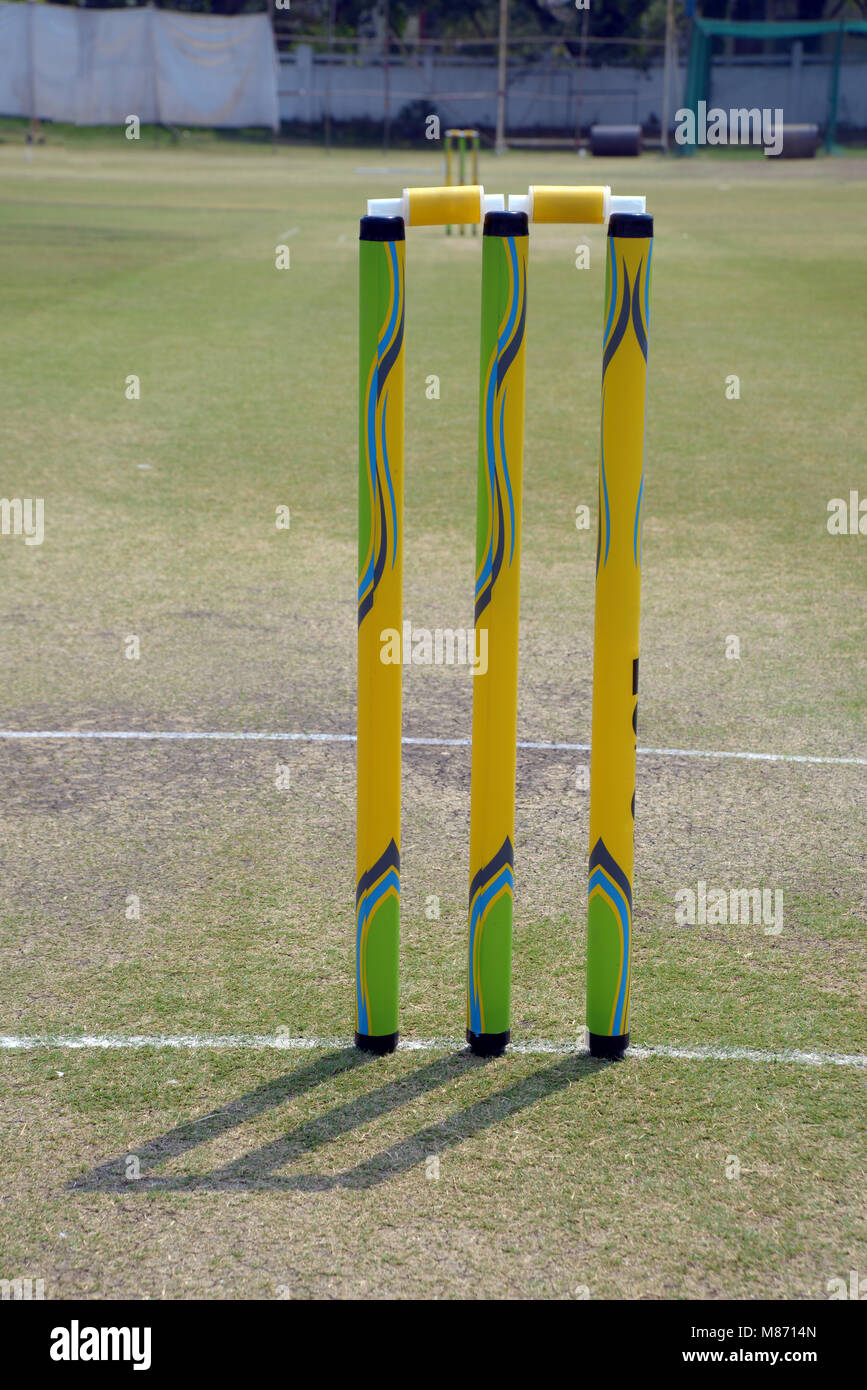 Cricket pitch with colorful stumps on playground Stock Photo