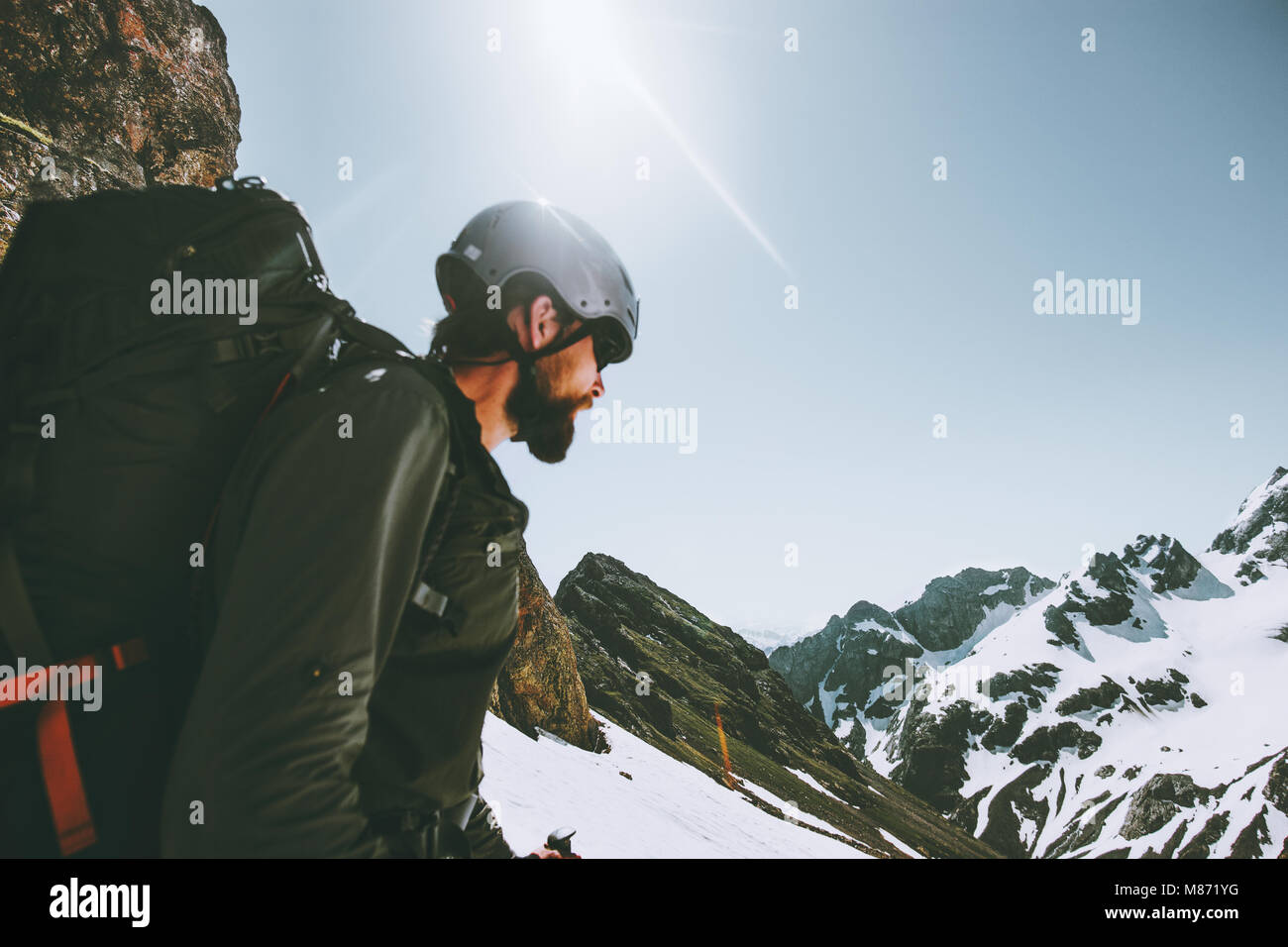 Man adventurer climbing on mountain top Travel adventure lifestyle concept outdoor active