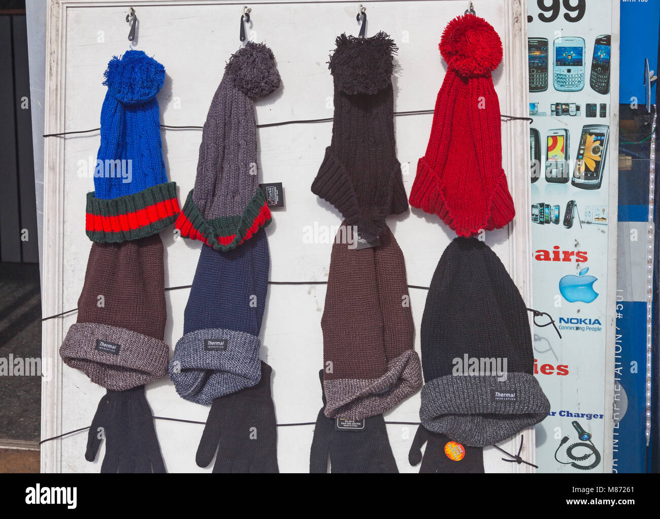 London, Borough of Lewisham  Beanies on display outside a shop in New Cross Road Stock Photo