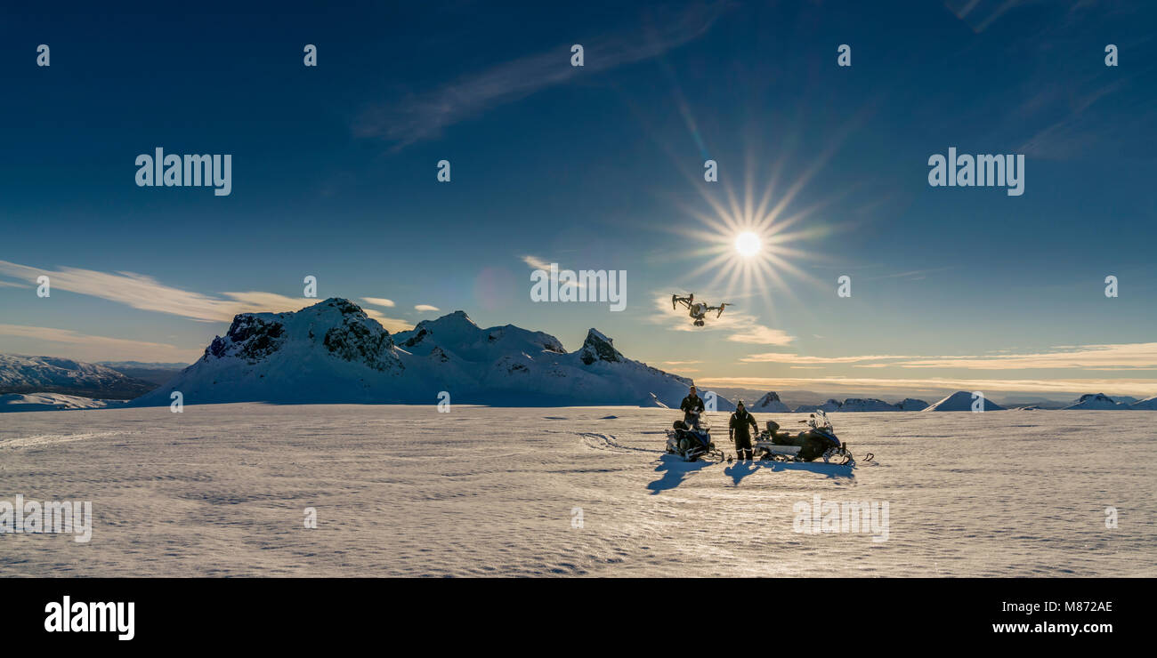 Photographer flying a drone, Hagafellsjokull Glacier,  Langjokull Ice Cap, Iceland.  Hagafellsjokull Glacier, Langjokull Ice Cap, Iceland. Stock Photo