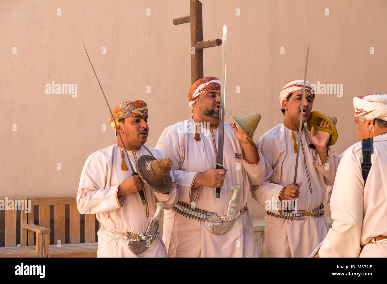 Nizwa, Oman - Omani men dancing a traditional sword dance at Nizwa Fort Stock Photo