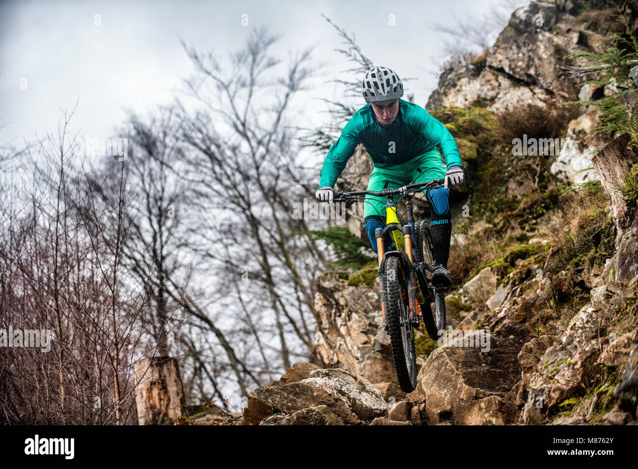 A mountain biker rides a rocky trail at Coed-y-Brenin in Snowdonia, North Wales. Stock Photo