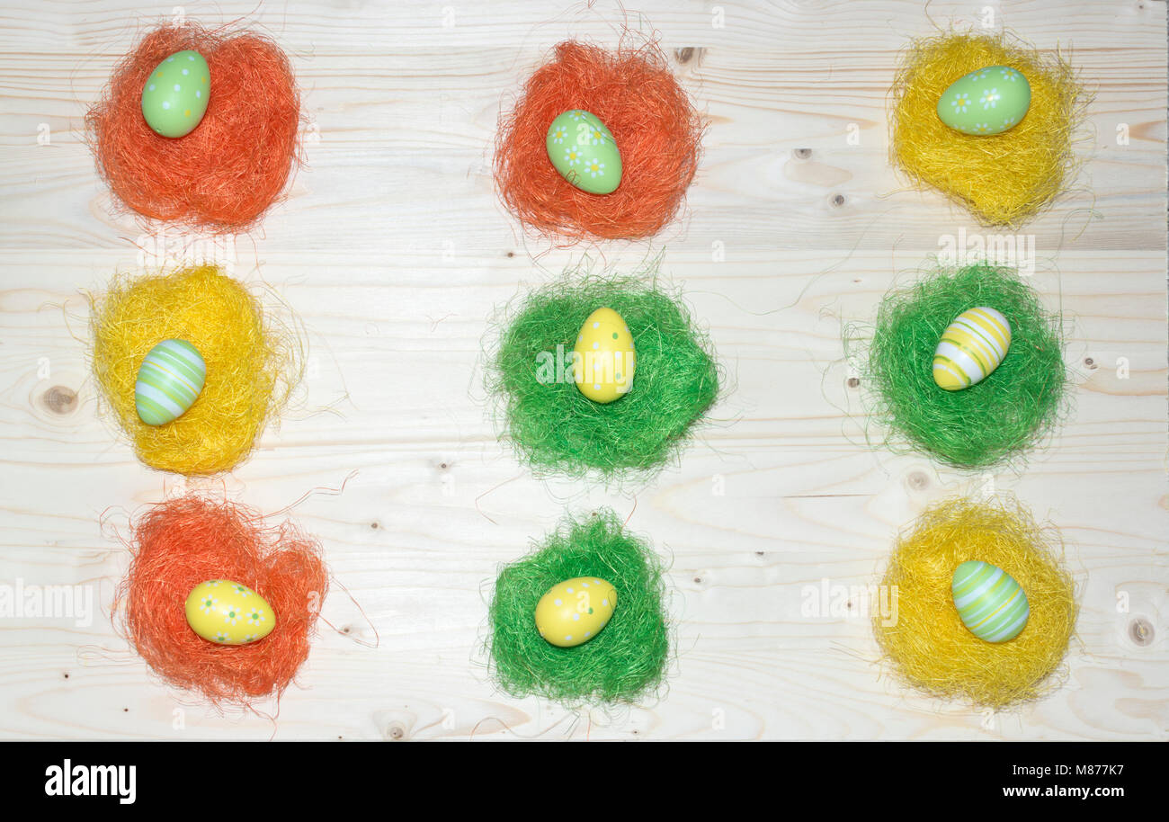 Color Easter eggs and straw on wood background nest birds Stock Photo ...