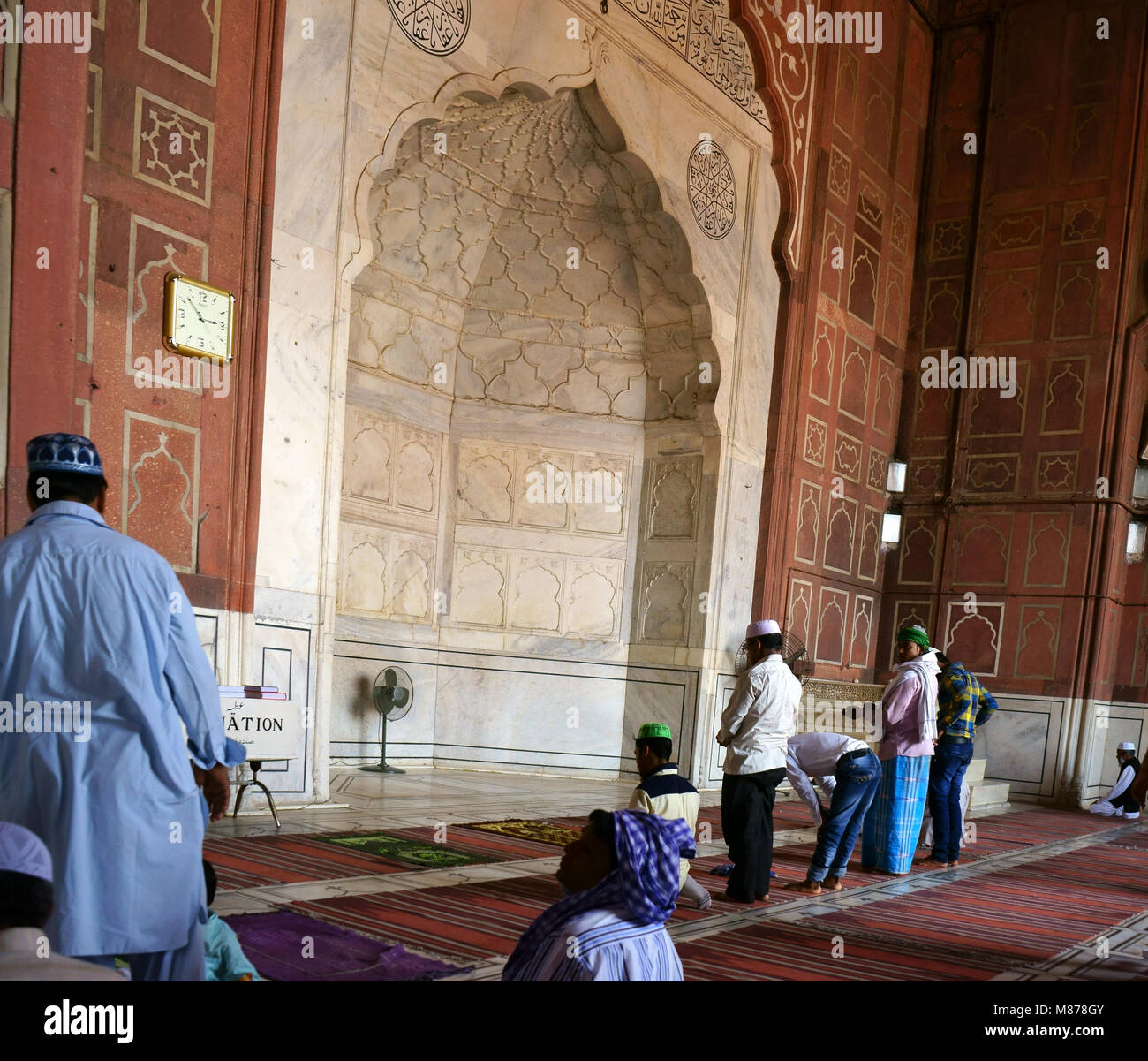 Muslim praying at Mihrab, Prayer Niche, during Friday Prayer, Jama Masjid Mosque, Old Delhi, India Stock Photo