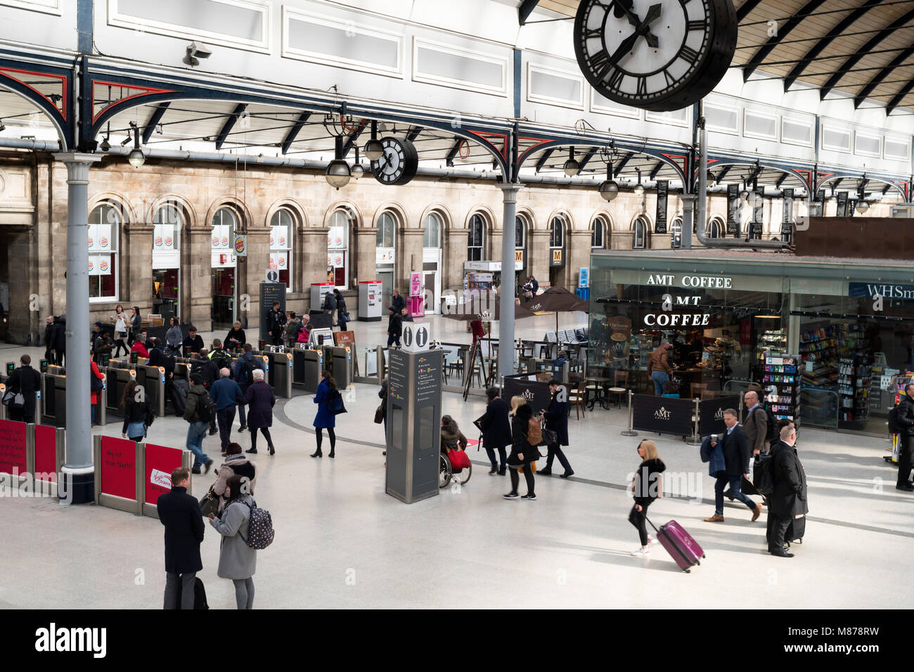 Group of people leaving the platform passing through barriers at Newcastle Central Station, north east England, UK Stock Photo