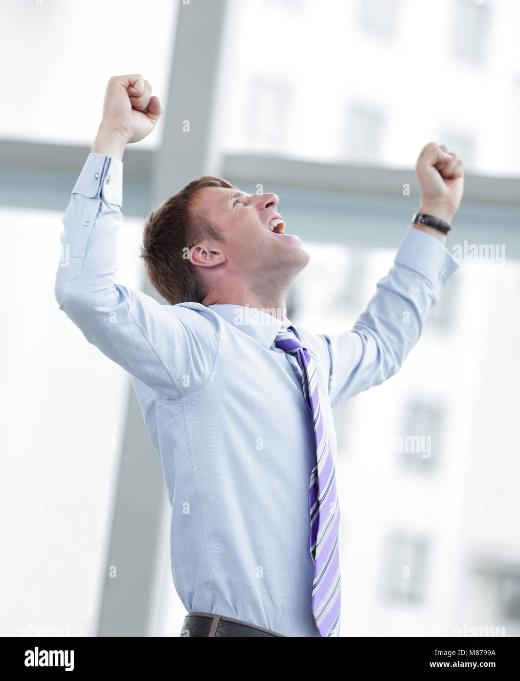 Businessman celebrating with his fists raised in the air Stock Photo ...