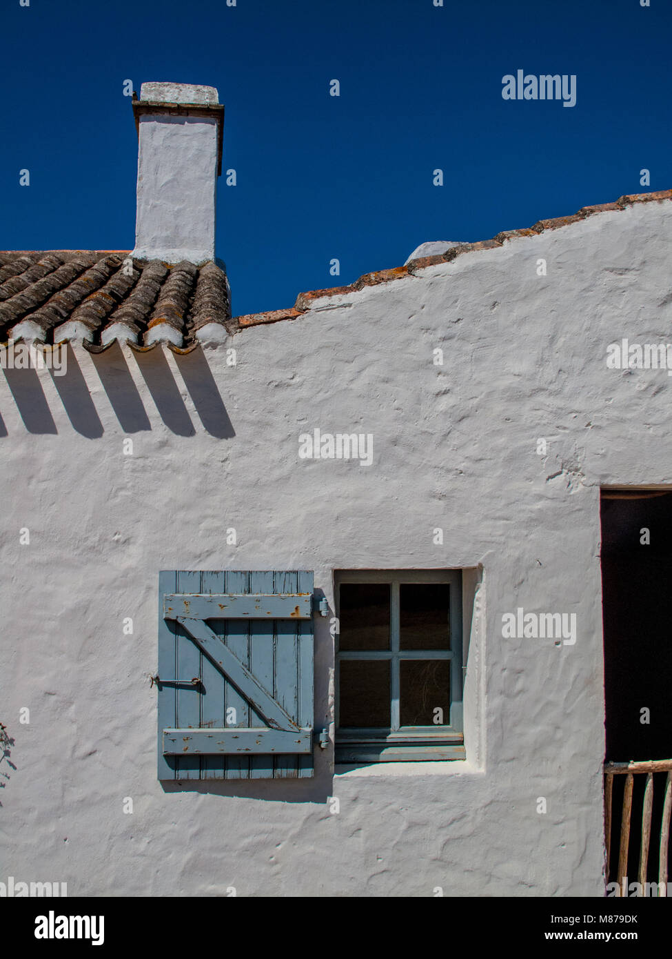 white walled building with blue sky Stock Photo Alamy