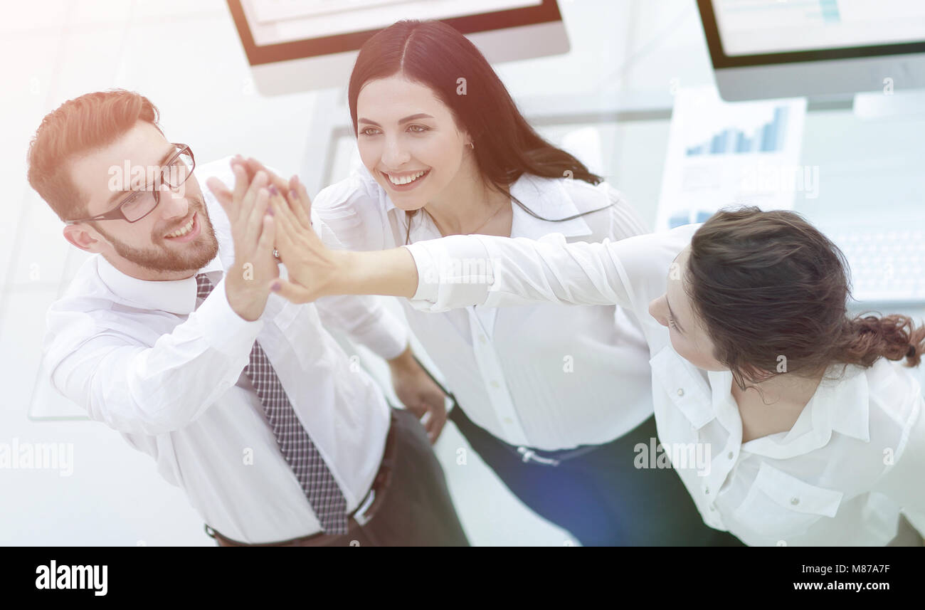 successful business team giving each other a high five Stock Photo - Alamy