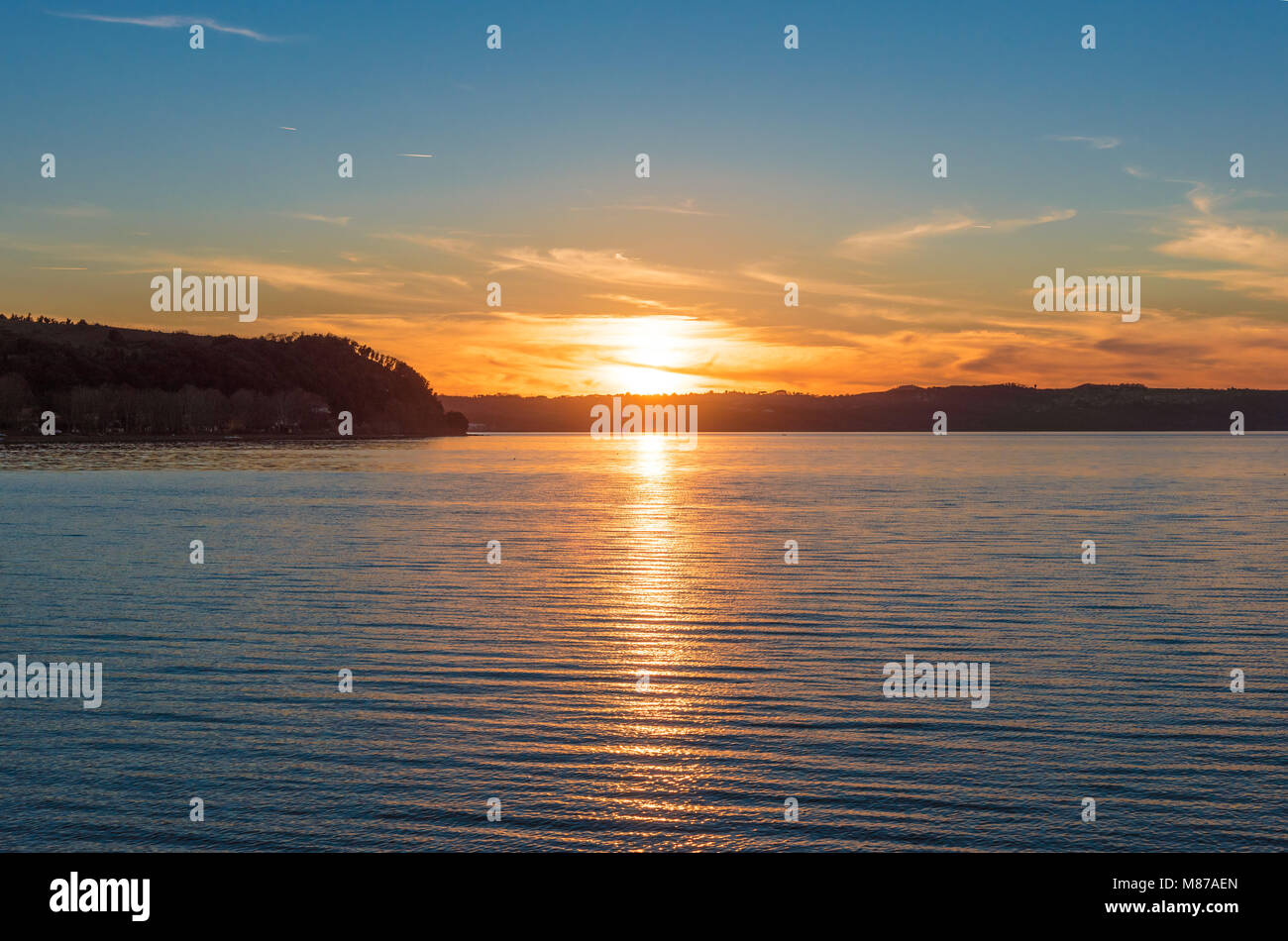 Anguillara Sabazia, Italy - The Bracciano lake at sunset from the old stone town on the waterfront. Province of Rome, central italy Stock Photo