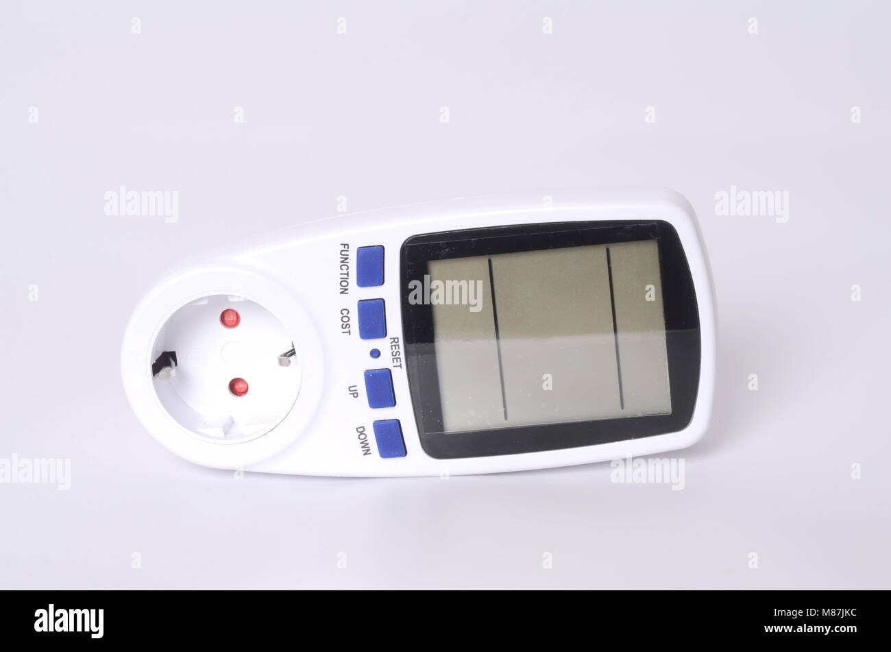 Watt Meter Plug in Operation on an Electrical Socket on the Wall Stock