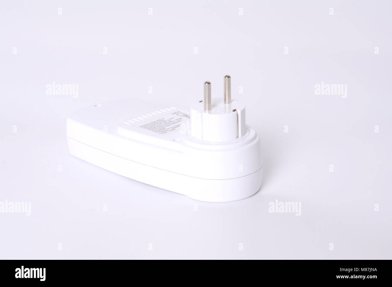 Watt Meter Plug in Operation on an Electrical Socket on the Wall Stock