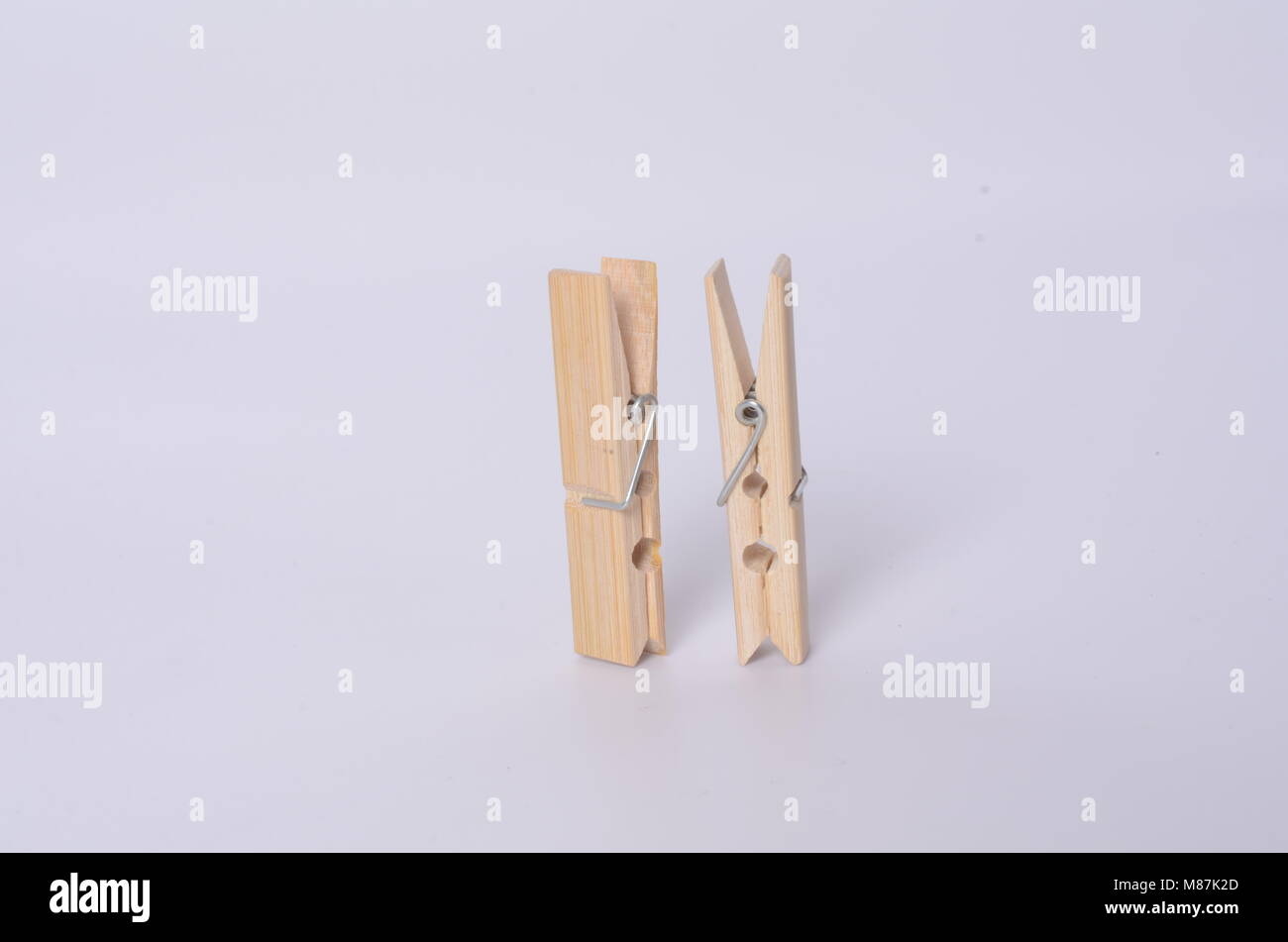 Some clothespins making a chain. It draws an abstract 69 number. Some wooden clothespins. Stock Photo
