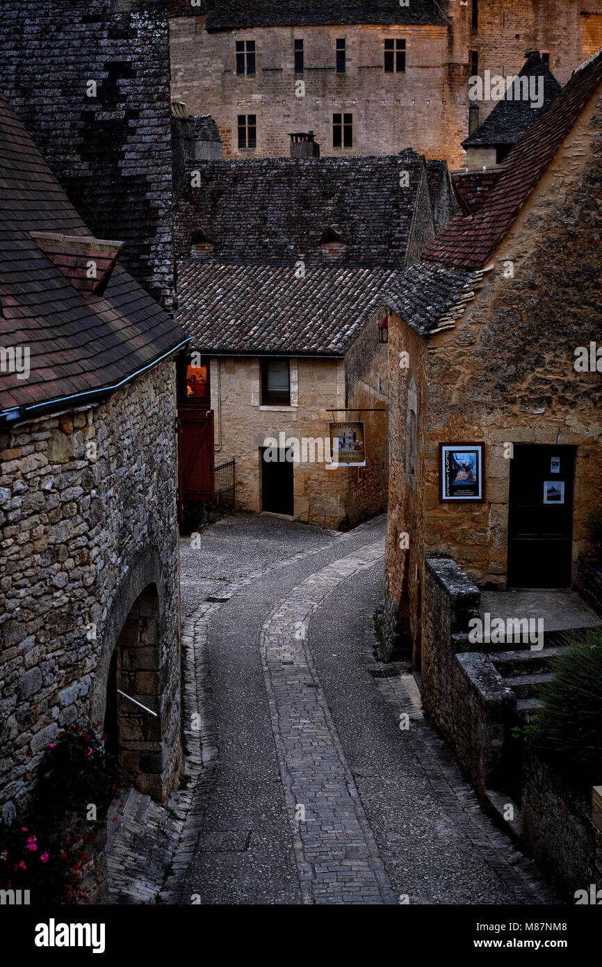 The narrow cobbled streets of Beynac et Cazenac at dusk in the Dordogne France. Stock Photo