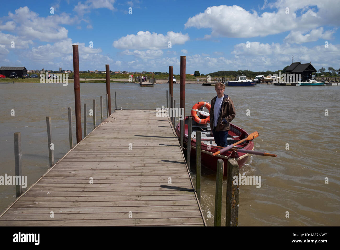 The ferryman of the Southwold-Walberswick ferry waiting for passengers. Walberswick, Suffolk, England. Stock Photo