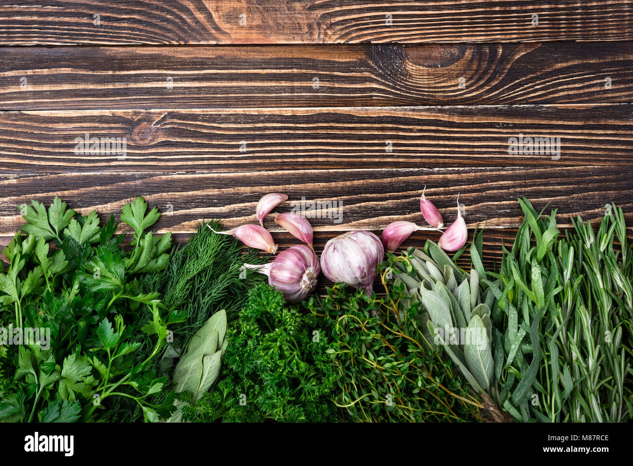 Fresh herbs and spices, garlic on old wooden background. Healthy food ...