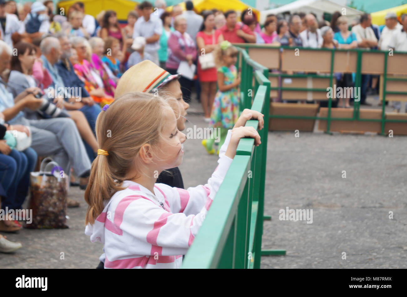Mstyora,Russia-August 16,2014: Children beside fences look concerto at day of the city Stock Photo