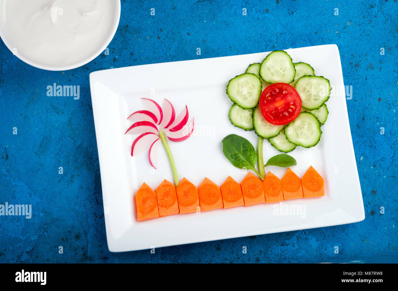 Funny vegetable salad for kids. Healthy food with vegetables tomato