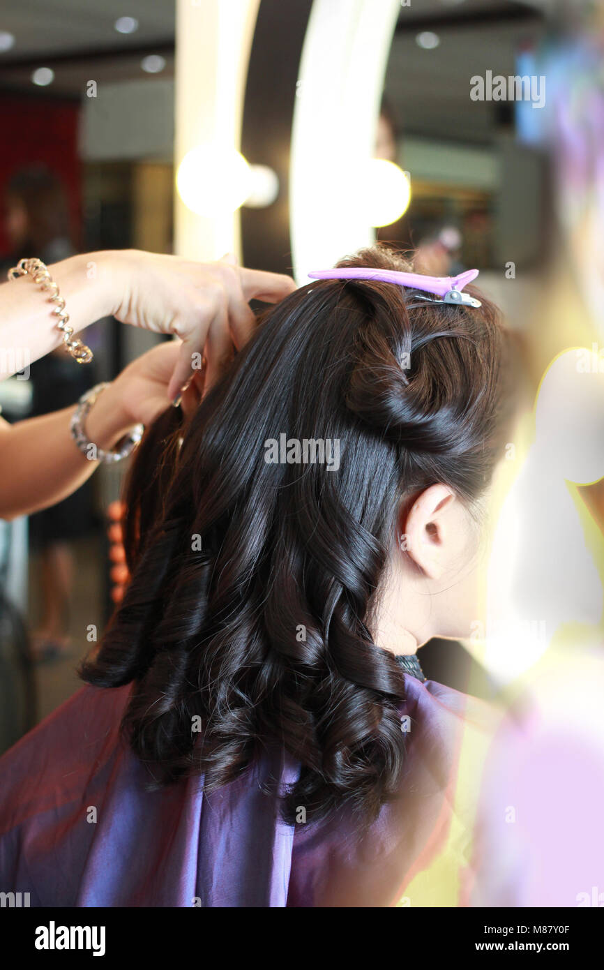 Professional stylist curling female hi-res stock photography and images ...