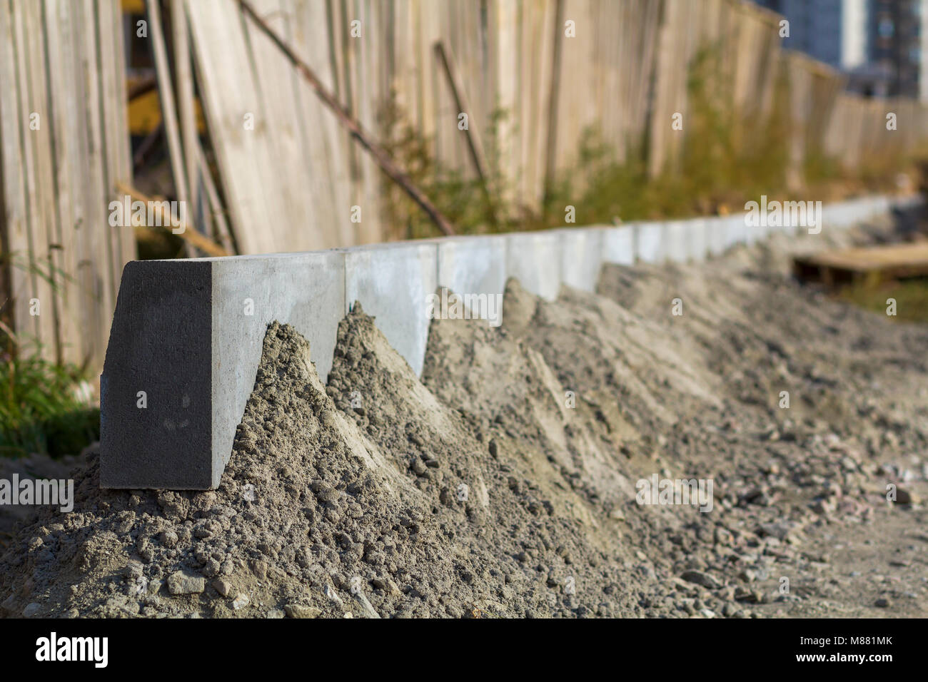 Concrete curb installation works at road construction site. Shallow DOF Stock Photo Alamy