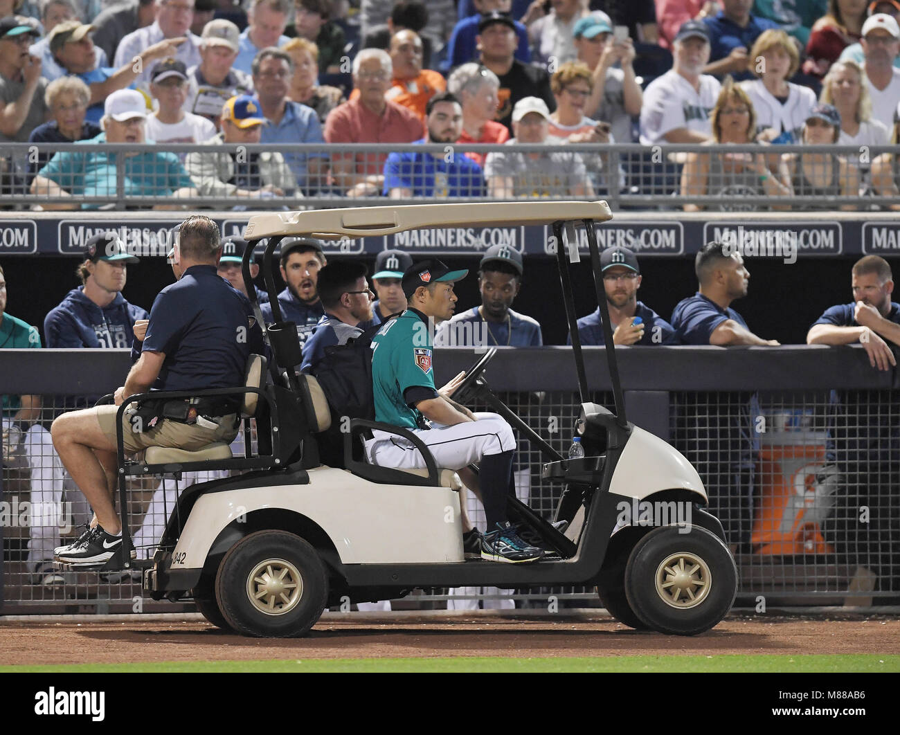 Ichiro Suzuki of the Seattle Mariners leaves the field riding in a golf