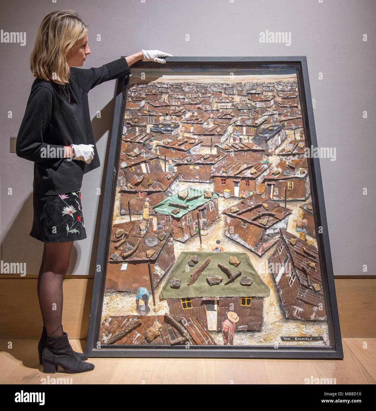 Bonhams, New Bond Street, London, UK. 16 March 2018. Sonnabo Infernal Settlement by Vusi Khumalo being hung for The South African Art Sale. It is estimated at £3,000-5,000. Credit: Malcolm Park/Alamy Live News. Stock Photo