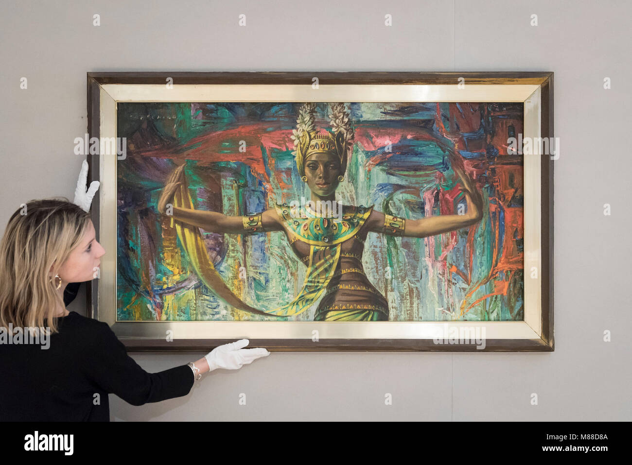 London, UK.  16 March 2018.  A staff member presents 'Balinese Dancer' by Vladimir Griegorovich Tretchikoff (Est. £25,000 - 35,000).  Preview of South African art at Bonhams, New Bond Street which will be sold at auction on 21 March 2018.  The sale features works by renowned South African artists including Irma Stern, Gerard Sekoto and Alexis Preller. Credit: Stephen Chung / Alamy Live News Stock Photo