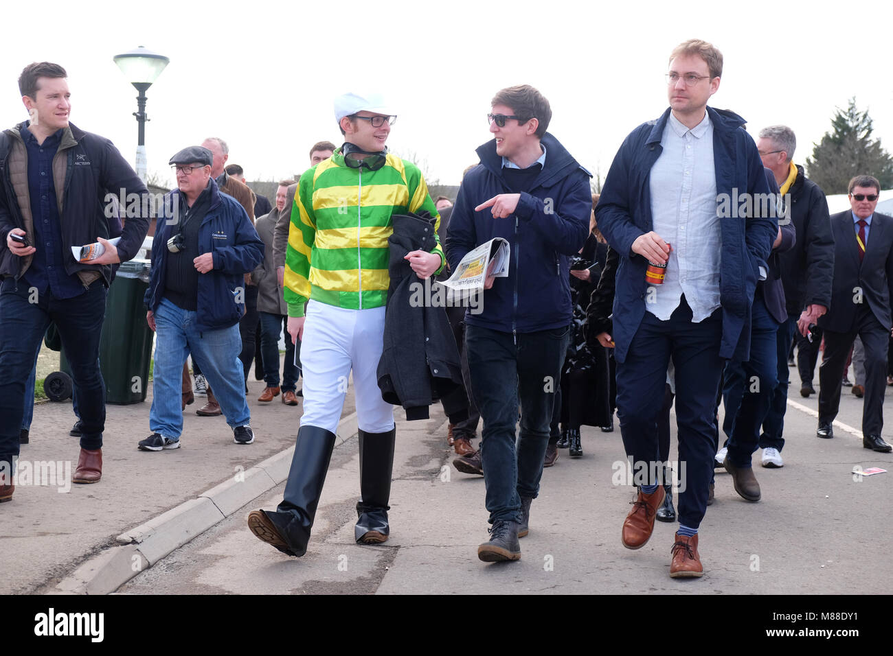 Cheltenham Festival, Gloucestershire, UK - Friday 16th March 2018 - Race goers including one dressed as a jockey arrive at the Cheltenham racing festival ahead of this afternoons classic Gold Cup race.  Steven May / Alamy Live News Stock Photo