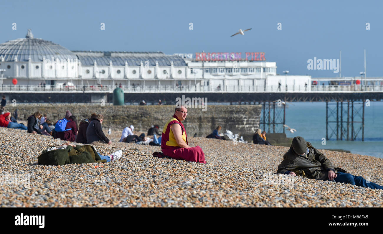 Brighton UK 16th March 2018  - Visitors enjoy warm sunshine on Brighton beach and seafront today but the weather is forecast to turn cold again with snow expected in some parts off Britain over the weekend Photograph taken by Simon Dack Credit: Simon Dack/Alamy Live News Credit: Simon Dack/Alamy Live News Stock Photo