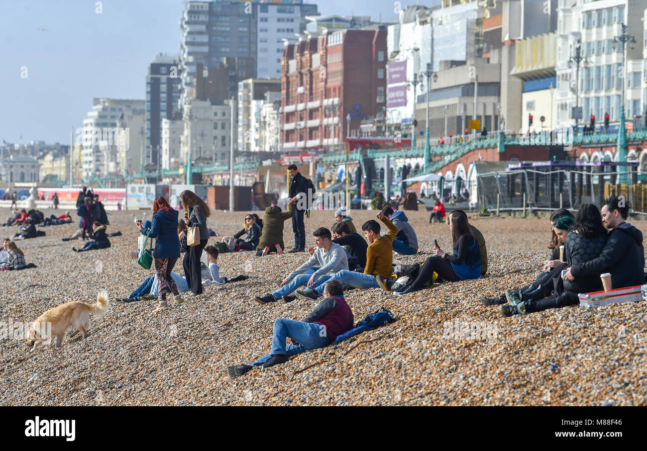 Brighton UK 16th March 2018  - Visitors enjoy warm sunshine on Brighton beach and seafront today but the weather is forecast to turn cold again with snow expected in some parts off Britain over the weekend Photograph taken by Simon Dack Credit: Simon Dack/Alamy Live News Credit: Simon Dack/Alamy Live News Stock Photo